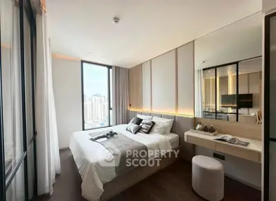 Luxurious modern bedroom with city view, featuring elegant decor and ample natural light.