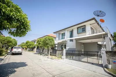 Modern two-story house with driveway and satellite dish in a suburban neighborhood.