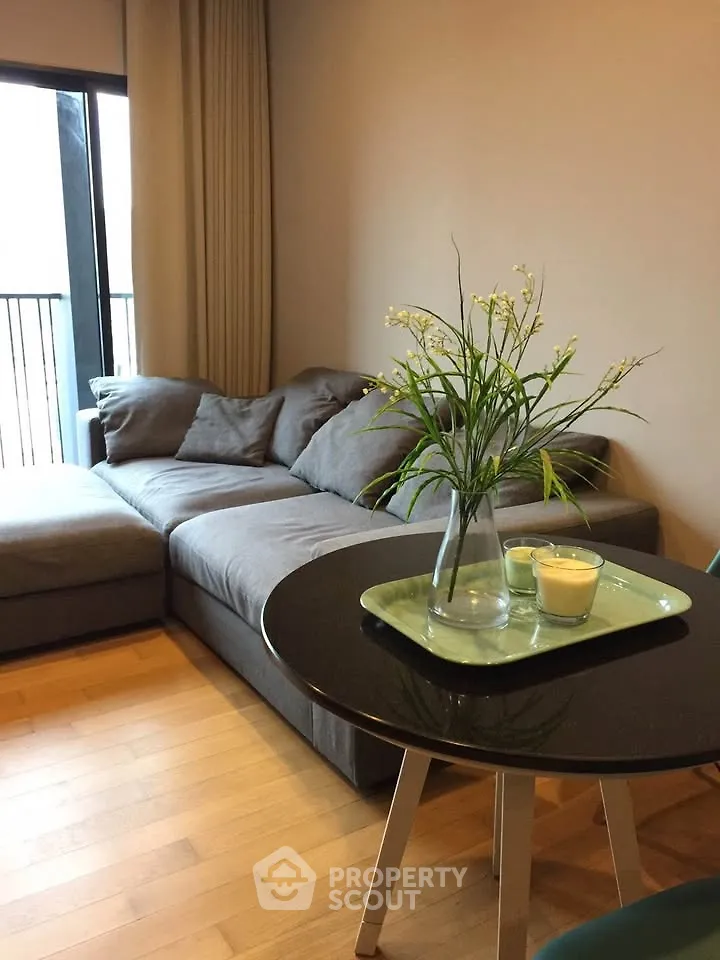 Cozy living room with stylish gray sofa and elegant decor, perfect for relaxation.