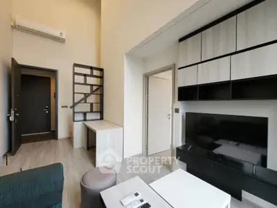 Modern living room with high ceiling, sleek furniture, and built-in storage in a stylish apartment.