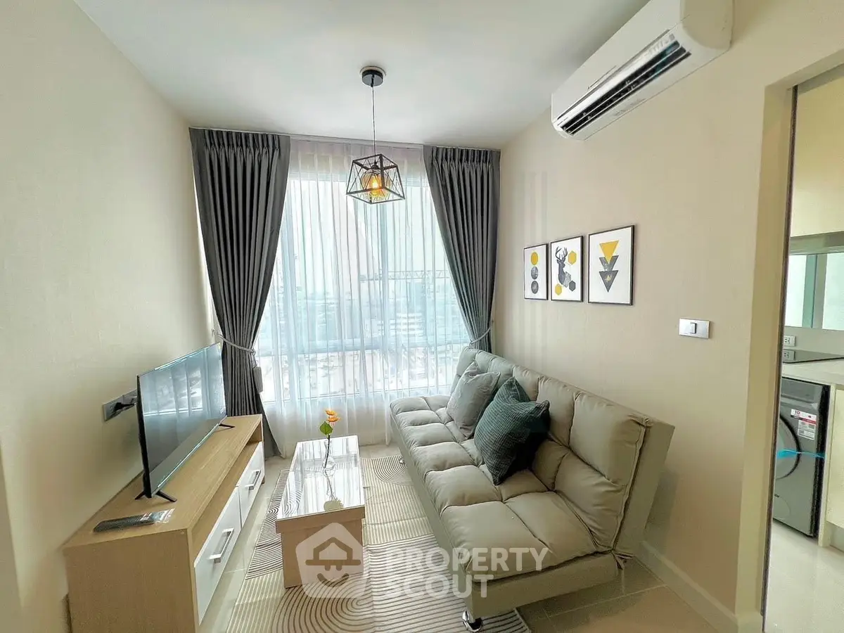 Modern living room with stylish decor, featuring a cozy sofa, wall-mounted TV, and large window with city view.