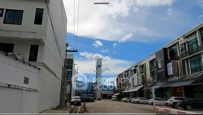 Modern commercial buildings with clear blue sky and mountain backdrop