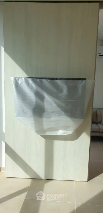 Modern living room with sleek wall-mounted TV setup and natural light