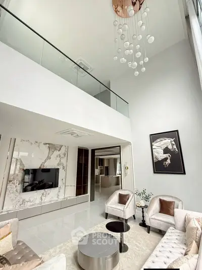 Luxurious modern living room with high ceiling and elegant decor, featuring plush seating and stylish chandelier.