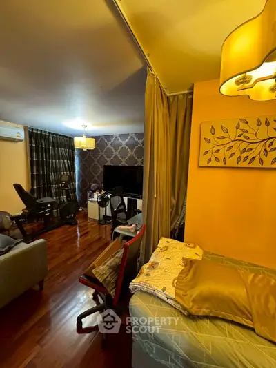 Cozy living room with wooden flooring, modern decor, and ambient lighting.