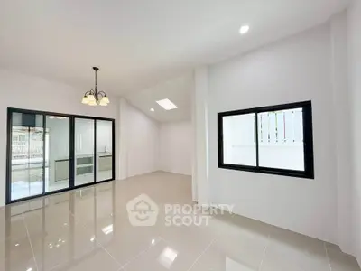 Spacious modern living room with large windows and elegant lighting