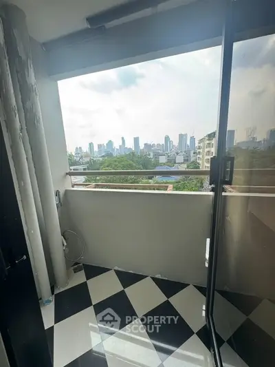 Chic urban balcony with stunning city skyline view, perfect for relaxation and enjoying the vibrant cityscape.