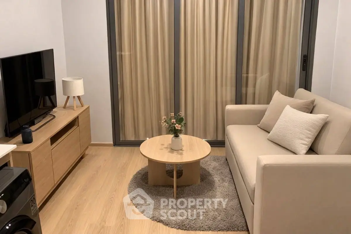 Cozy modern living room with beige sofa, TV, and elegant decor