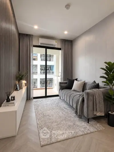 Modern living room with elegant decor and balcony view in a stylish apartment.