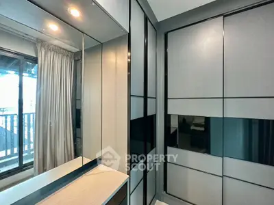 Modern bedroom with sleek built-in wardrobes and large window view