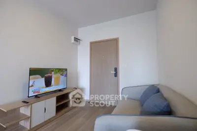 Cozy living room with modern sofa and flat-screen TV in a stylish apartment.