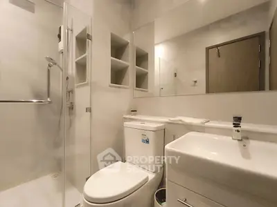 Modern bathroom with sleek fixtures and glass shower enclosure