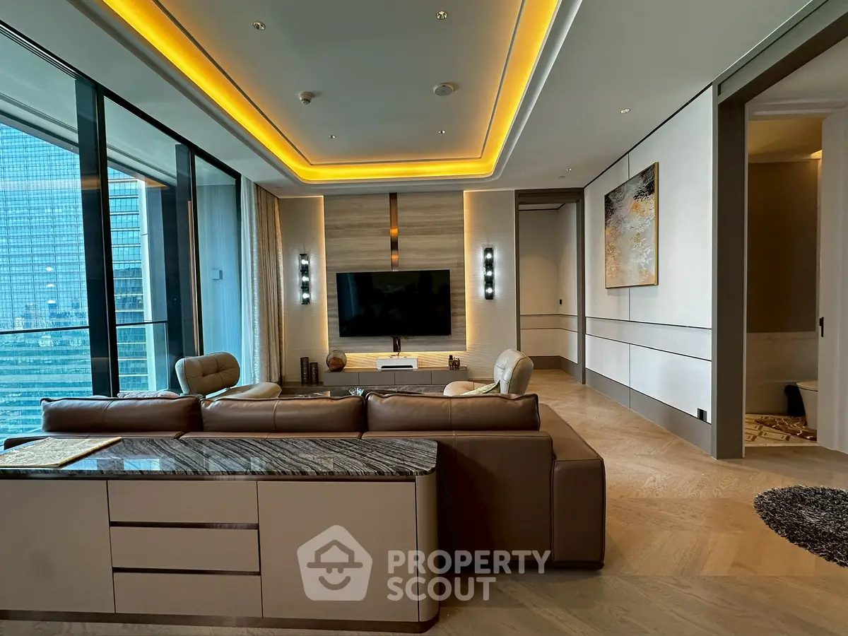 Luxurious modern living room with city view, featuring elegant lighting and stylish decor.