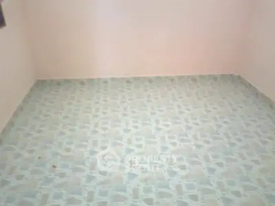 Spacious empty room with tiled flooring, ready for customization.