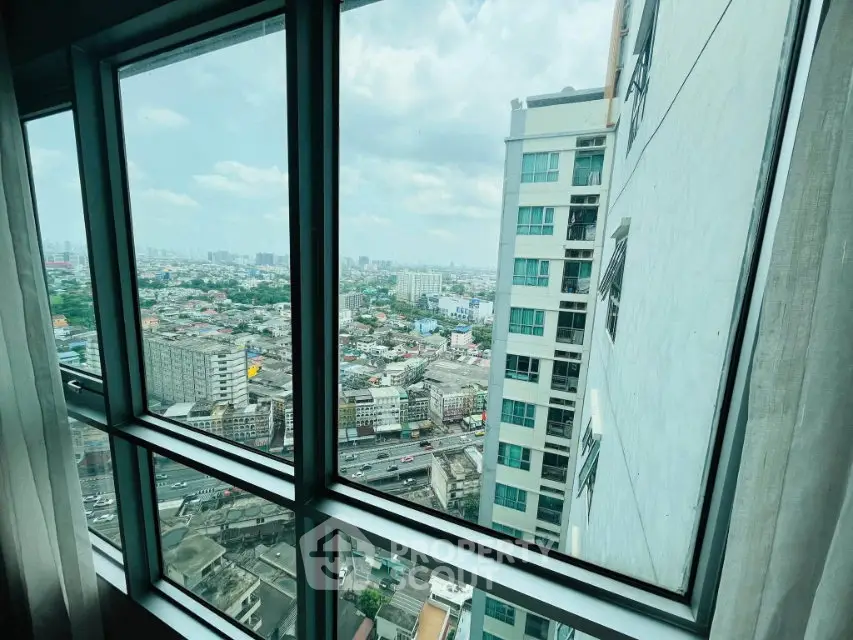 Stunning cityscape view from high-rise apartment window, showcasing urban living and skyline.