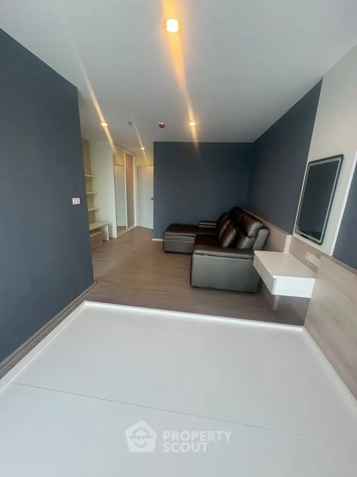 Modern living room with sleek design and comfortable seating in a stylish apartment.