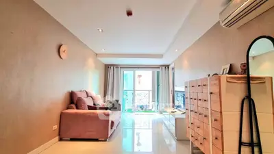Spacious living room with modern decor and natural light in a stylish apartment.