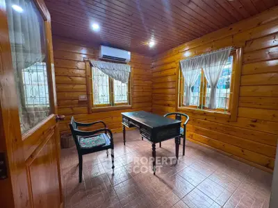 Charming wooden study room with natural light and cozy ambiance