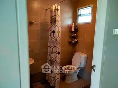 Cozy bathroom with shower curtain and modern fixtures