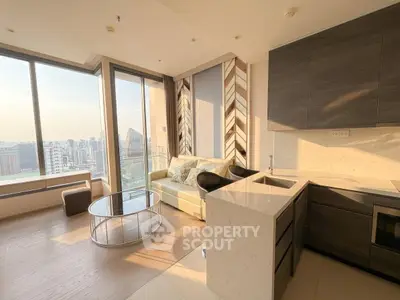 Modern living room with open kitchen and stunning city view from large windows.