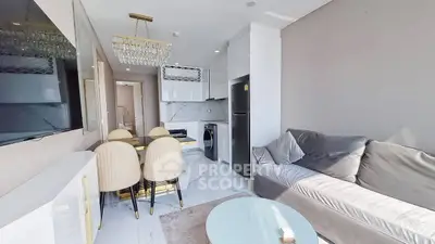 Modern living room with elegant dining area and sleek kitchen appliances.