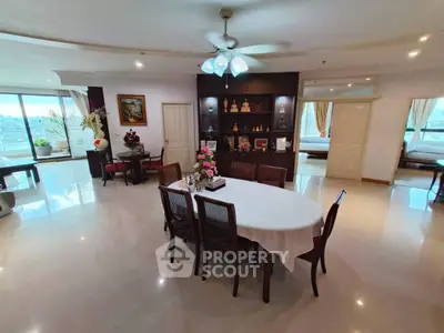 Spacious open-plan living and dining area with elegant decor and ample natural light.