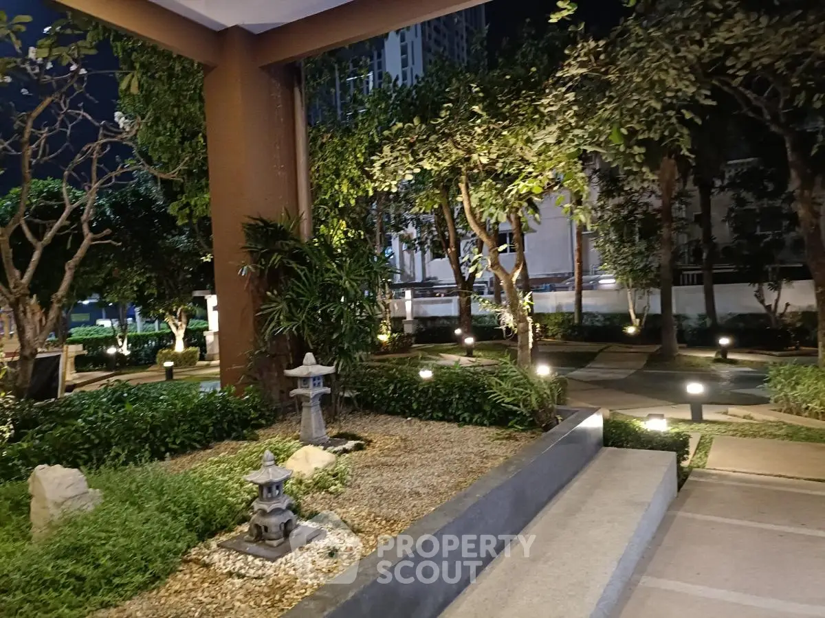 Serene garden view with ambient lighting in modern residential complex