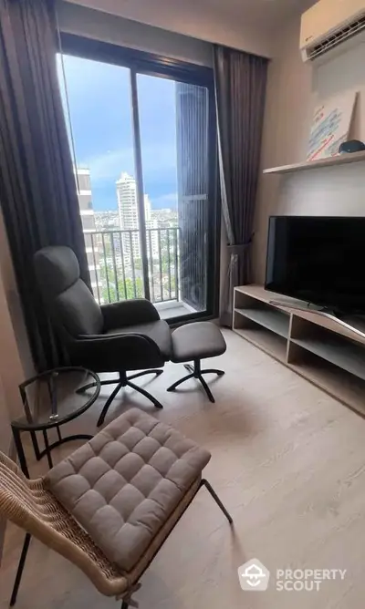 Modern living room with city view, stylish furniture, and large window in high-rise apartment.