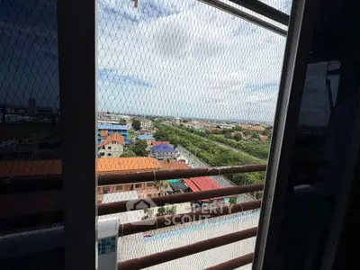 Stunning high-rise view showcasing lush greenery and urban landscape from a balcony.
