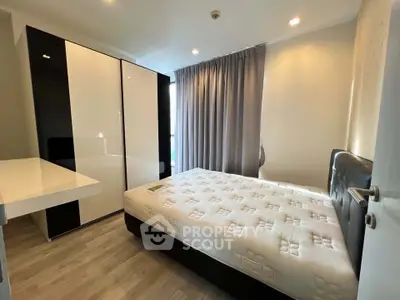 Modern bedroom with sleek design, featuring a comfortable bed and spacious wardrobe, perfect for urban living.