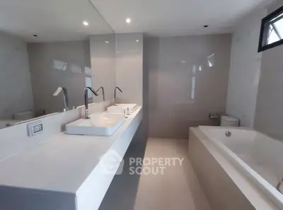 Luxurious modern bathroom with dual sinks and spacious bathtub