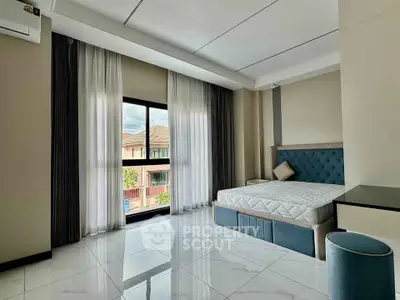 Spacious modern bedroom with large window and elegant decor