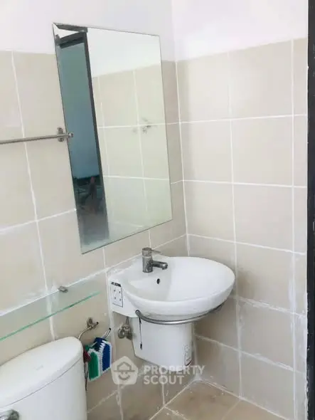 Compact bathroom with modern sink and mirror, ideal for small spaces.