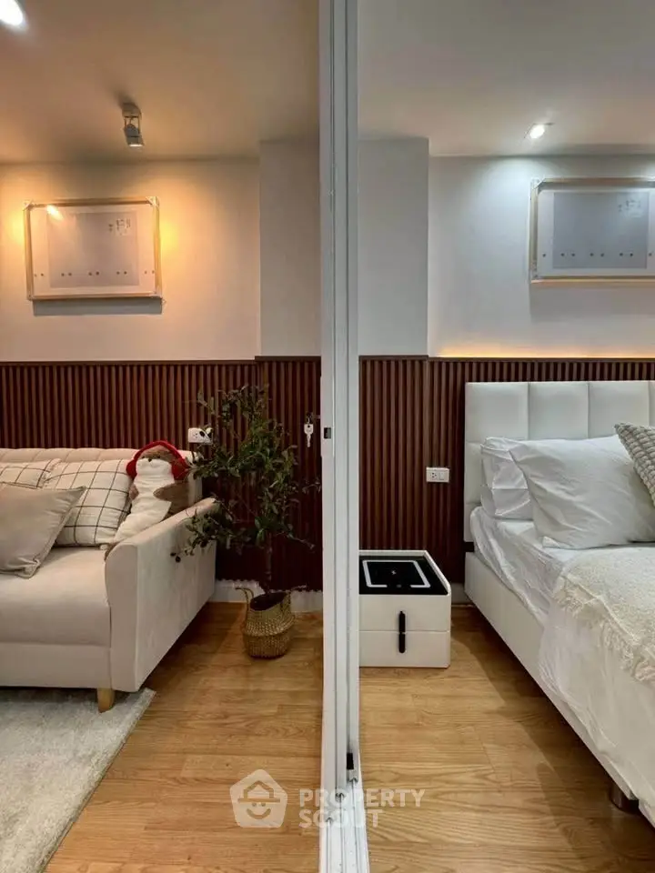 Modern interior with cozy living room and elegant bedroom separated by a sleek partition.