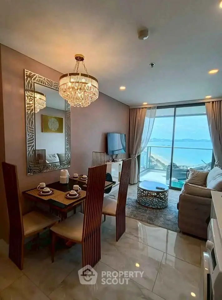 Luxurious beachfront living room with elegant dining area and stunning ocean view.