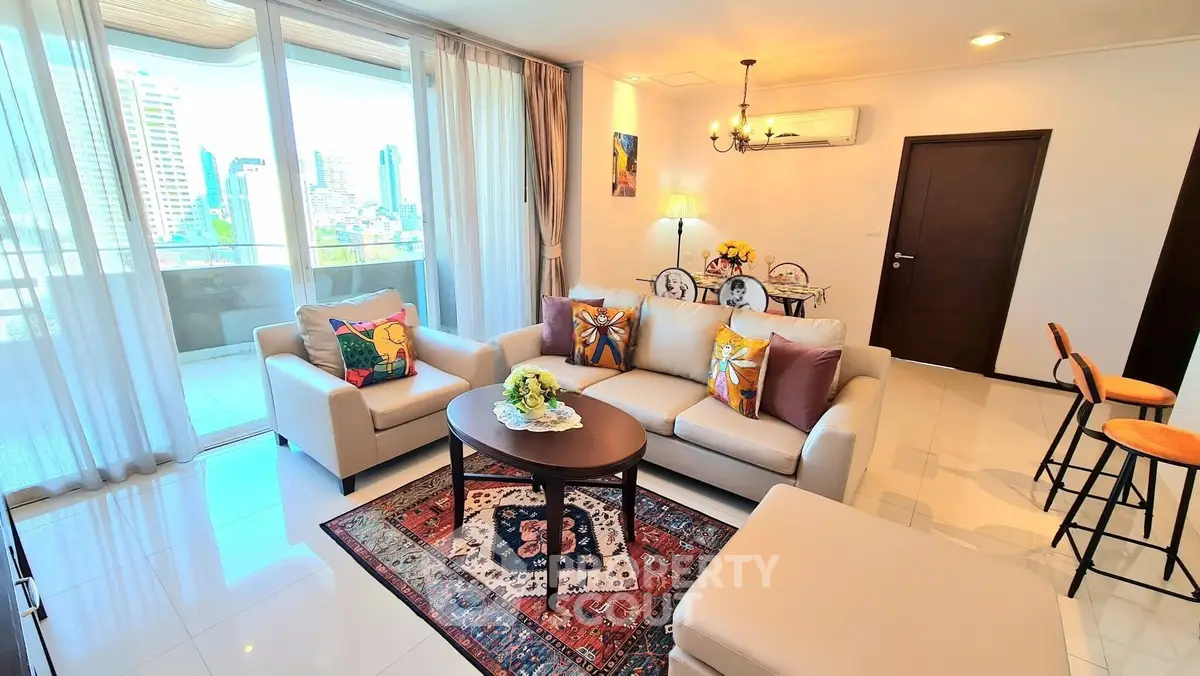 Spacious living room with modern decor and city view balcony in luxury apartment.