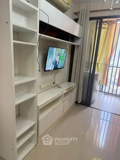 Modern living room with sleek white furniture and balcony view