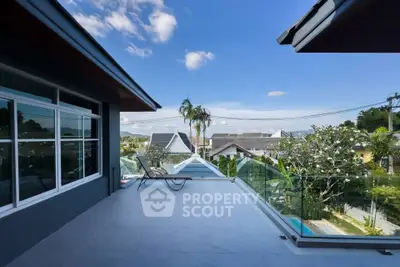 Spacious balcony with stunning view of suburban neighborhood and clear blue sky.