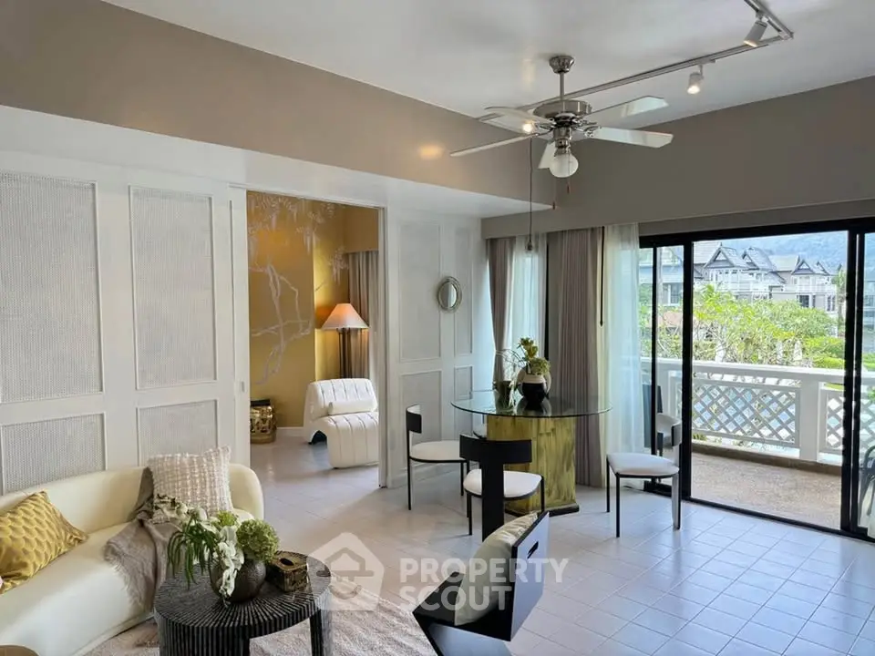 Spacious living room with modern decor and large windows offering scenic views.