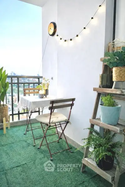 Charming balcony with cozy seating and lush greenery, perfect for relaxation.