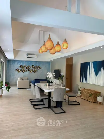 Spacious modern living room with elegant decor and stylish lighting, perfect for entertaining guests.