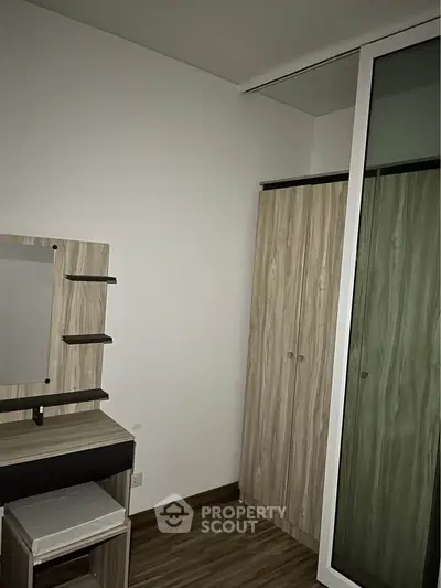 Modern bedroom with sleek wooden wardrobe and vanity set, perfect for stylish living.