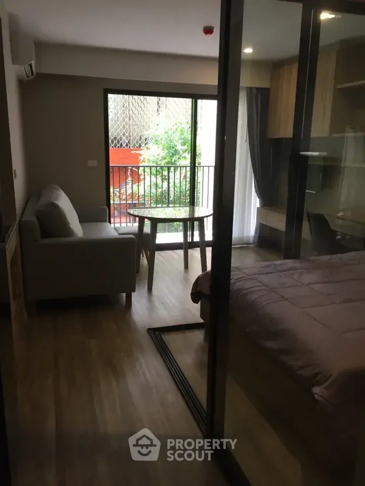 Modern studio apartment with glass partition and balcony view