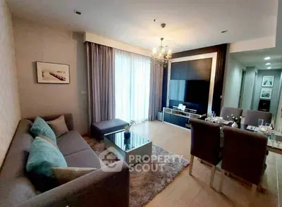 Elegant living room with modern decor and large TV, perfect for relaxation.
