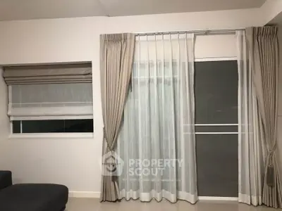 Modern living room with elegant curtains and large window