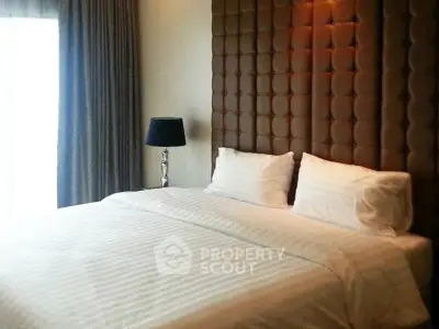 Luxurious bedroom with elegant decor and plush bedding in a modern apartment.