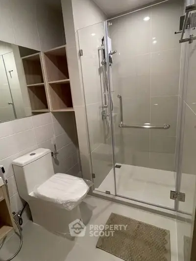 Modern bathroom with glass shower and sleek fixtures