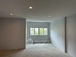 Spacious unfurnished room with large windows and natural light