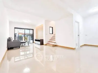 Spacious modern living room with sleek tile flooring and natural light