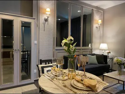 Elegant living room with stylish dining setup and cozy seating area